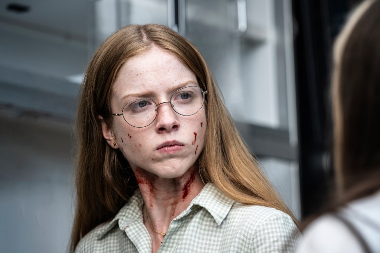 Julia Doyle as Sofia in FROM Season 4 with blood on her face and neck during a tense confrontation scene